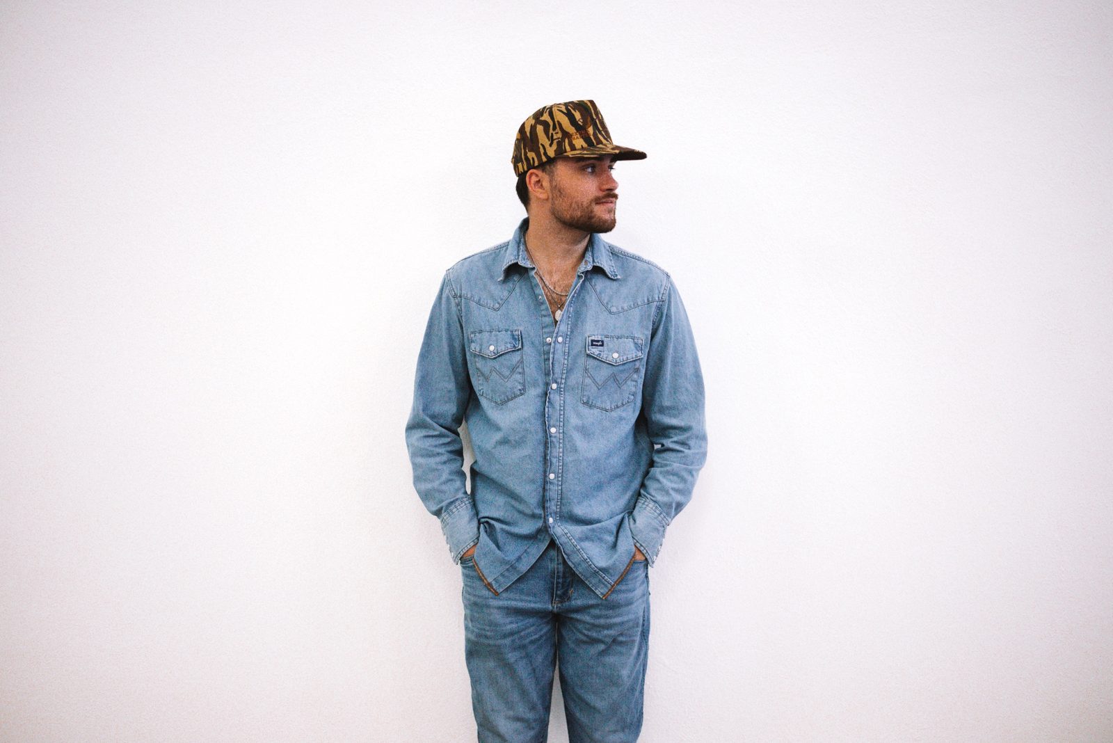 Matt Mueller standing against a white wall