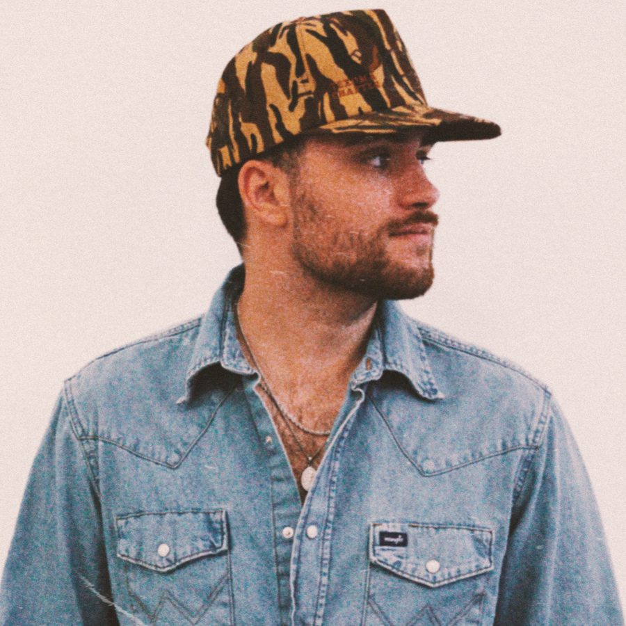 Matt Mueller in a denim western shirt and camo cap